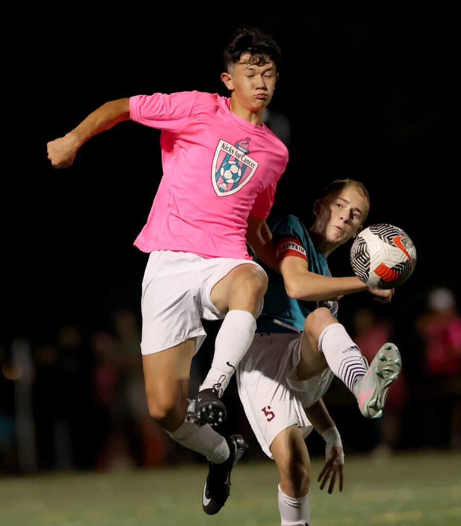 CC’s Nate Seeley, left, battles a Lincoln-Sudbury defender for the ball. 
