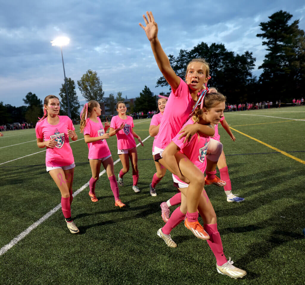 CC’s Kendall Johnson, who injured her leg during the game, is carried off after the dramatic come-from-behind Patriots victory.
