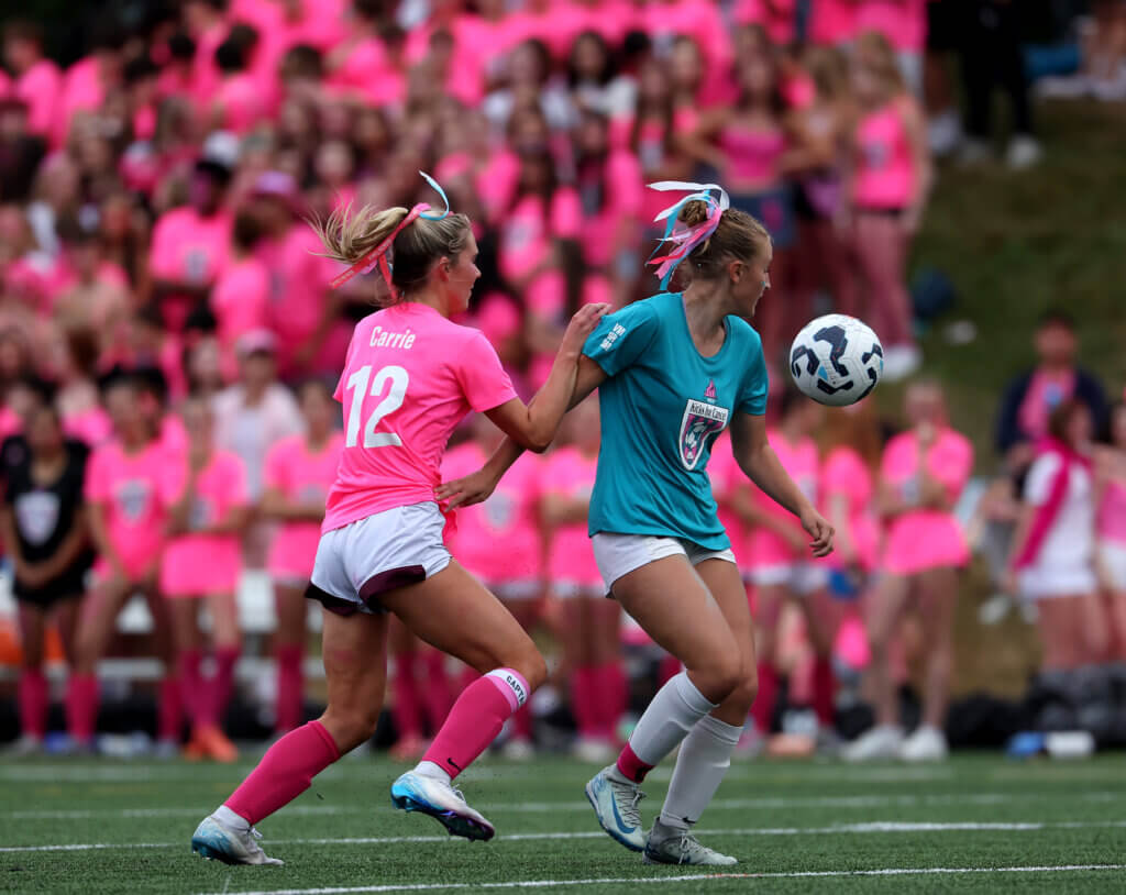 Acton-Carlisle senior captain Liv Delaney, left, battles a Lincoln-Sudbury player.
