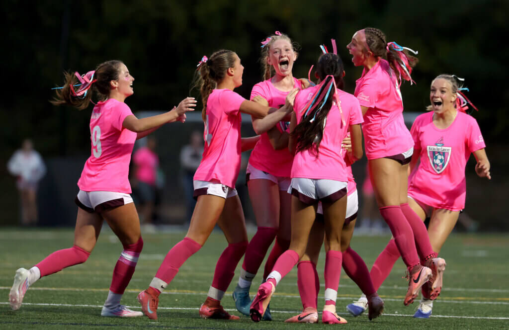 Players mob teammate Natalie Saak.

