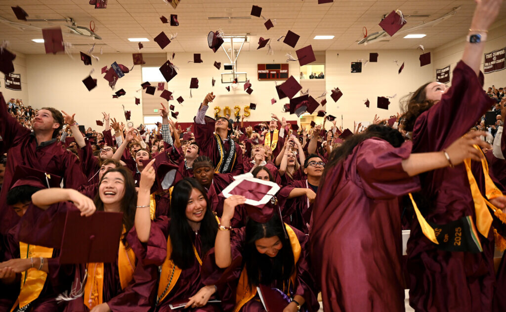 Members of the Class of 2025 toss their mortarboards into the air at the conclusion of Saturday’s CCHS commencement. Photo: Ken McGagh/The Acton Bridge 