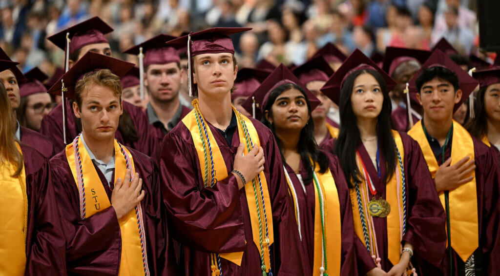 Acton-Carlisle High School seniors stand for the national anthem. Photo: Ken McGagh/The Acton Bridge 
