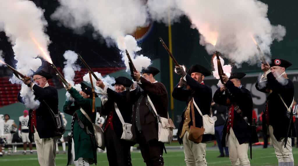 The Acton Minute Men fire a musket volley at the conclusion of the anthem. 
