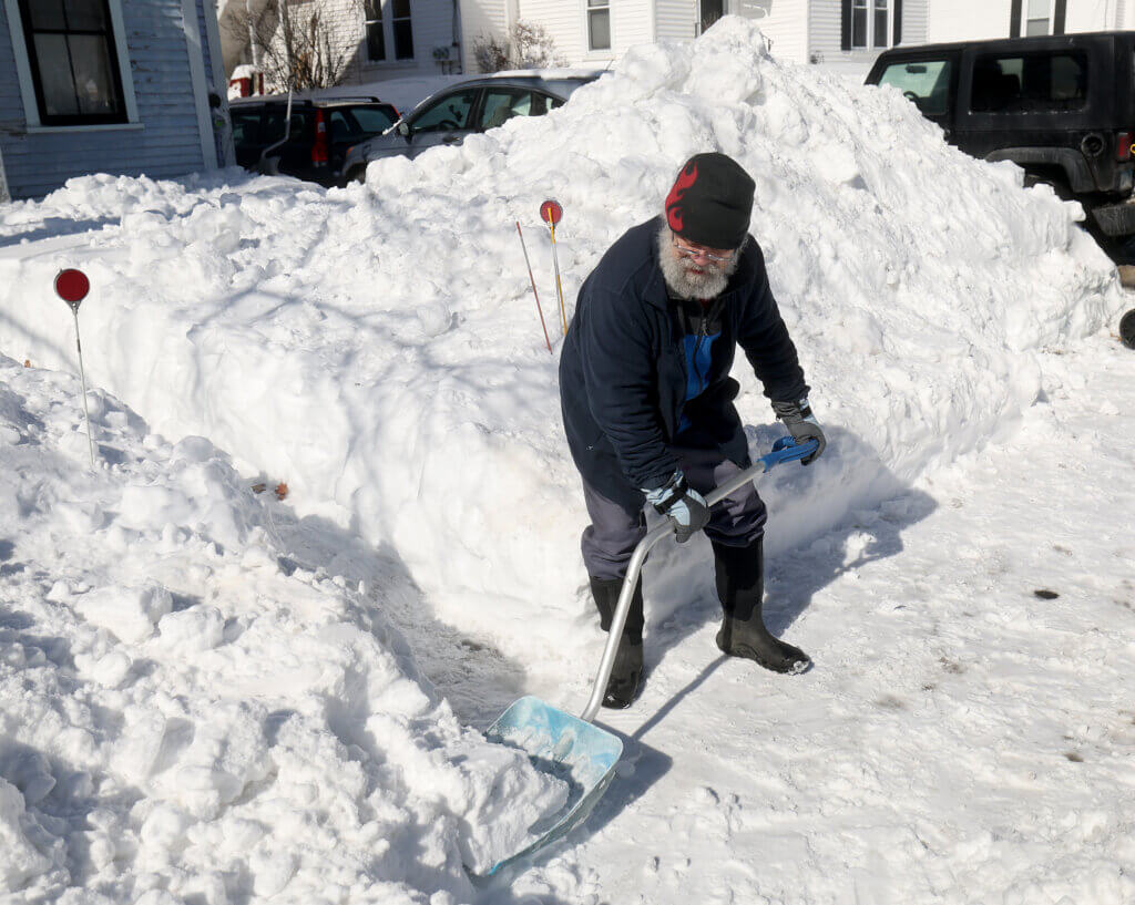 Jimi Two Feathers digs out of his West Acton home. Photo: Ken McGagh/The Acton Bridge