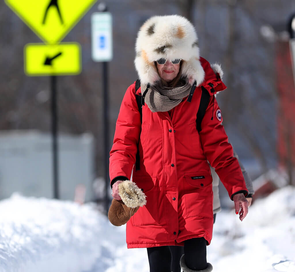Jeanne Moore of Acton keeps warm in style while walking in West Acton village. Photo: Ken McGagh/The Acton Bridge