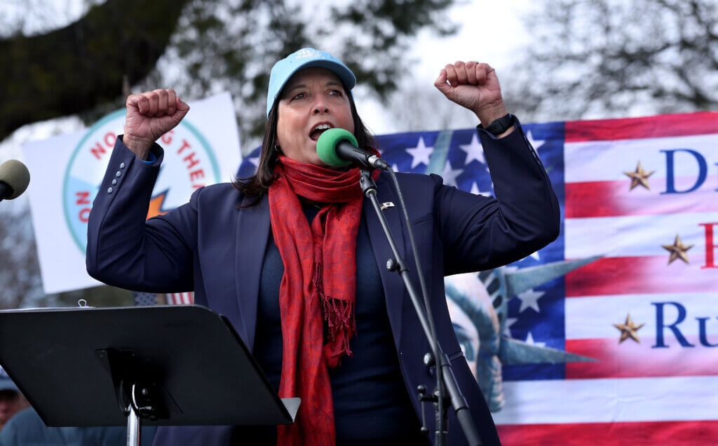 Lt. Gov. Kim Driscoll raises her fists during her address to the rallygoers. Photo: Ken McGagh/The Acton Bridge 

