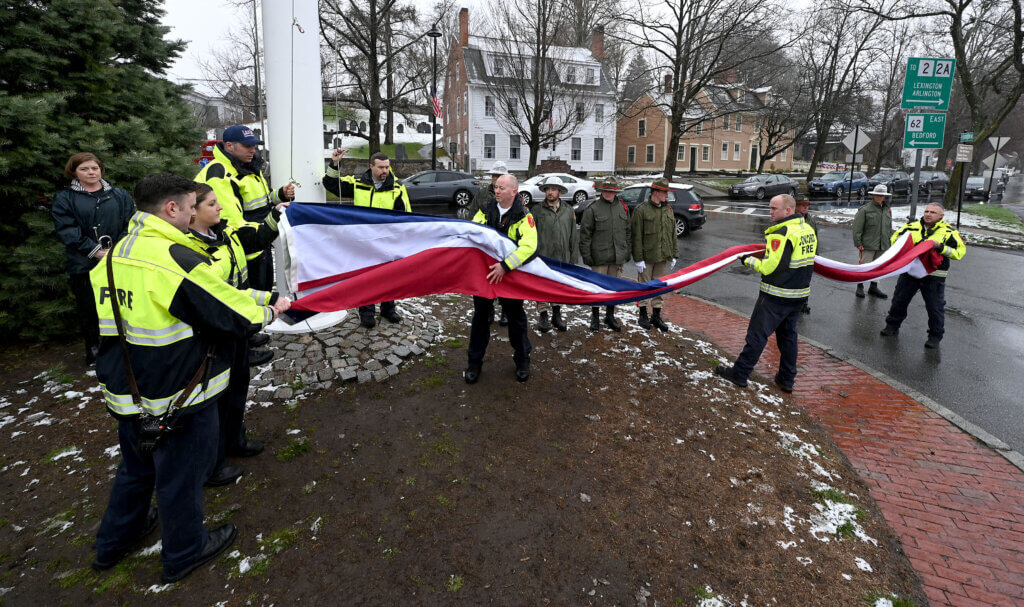 Acton firefighers prepare to raise a new 15’x25’ American flag during a flag-raising certemony in Acton Center on Saturday, April 12, 2025.  Ken McGagh/The Acton Bridge