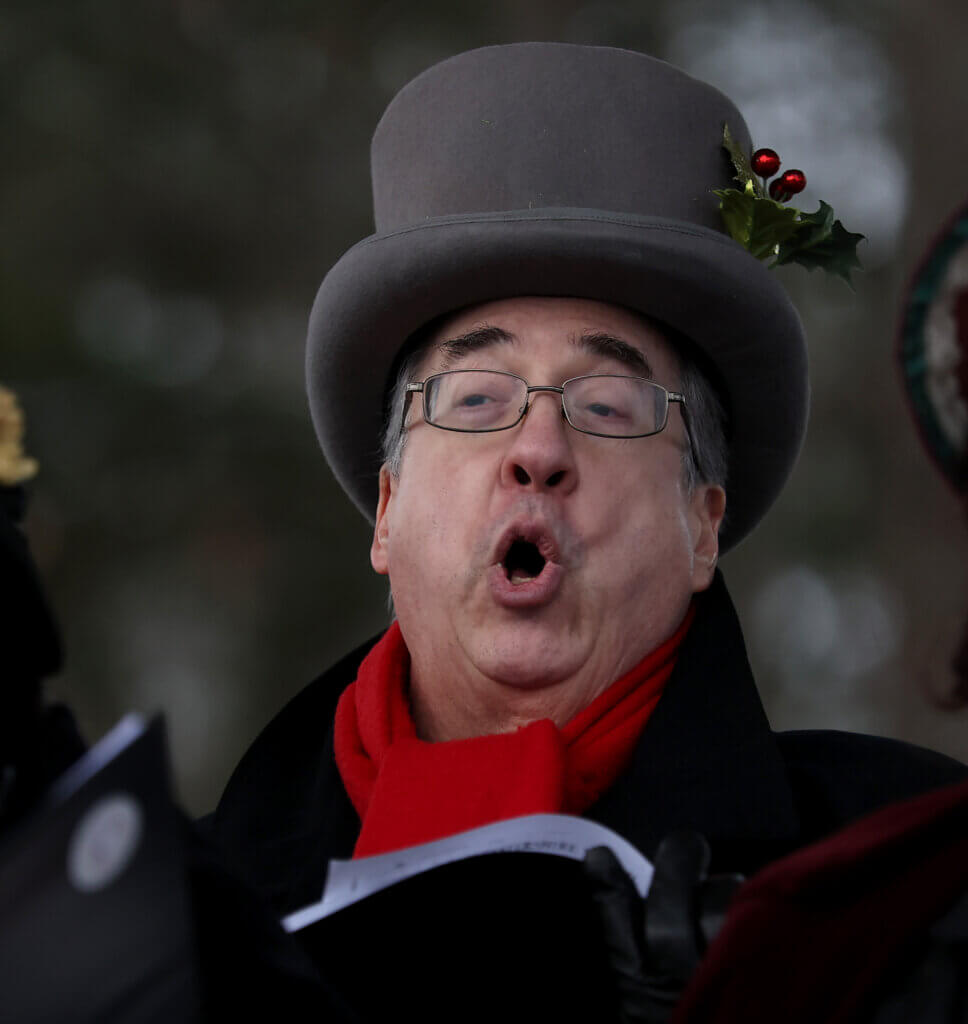 Craig Howard hits a note while singing Christmas songs with his fellow Acton Players  choir members during the town’s annual Tree Lighting on Sunday, December 7, 2025.  Ken McGagh/The Acton Bridge