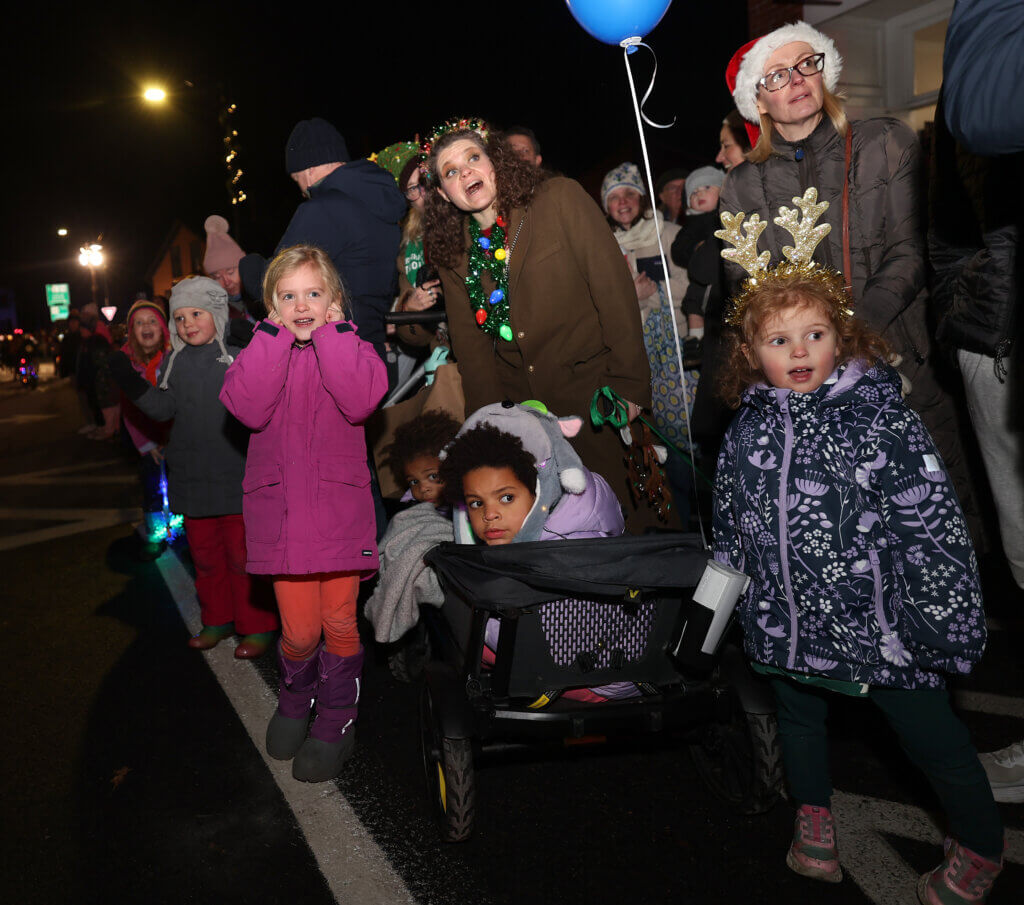 Children and adults spot Santa Claus atop a Acton Fire Department ladder truck during the town’s annual Tree Lighting on Sunday, December 7, 2025. Ken McGagh/The Acton Bridge