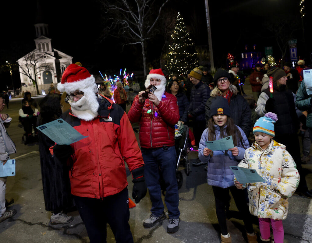 People take part in a holiday sing-a-long on the main stage at the conclusion of the town’s annual Tree Lighting on Sunday, December 7, 2025. Ken McGagh/The Acton Bridge