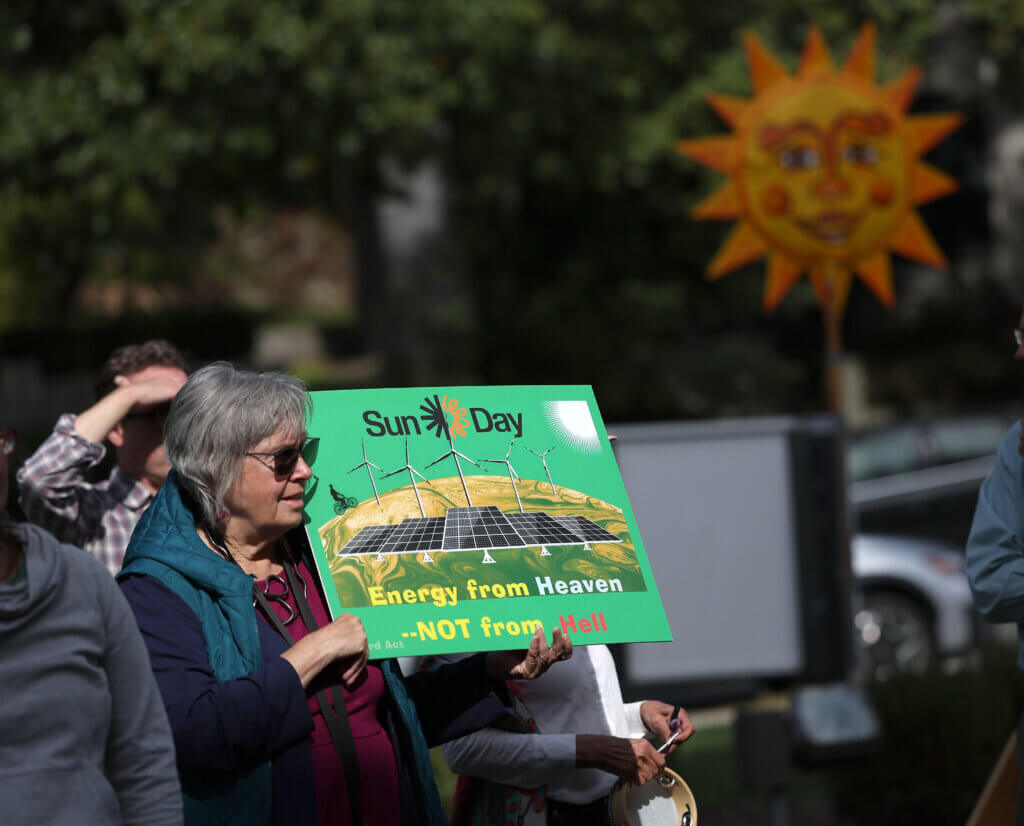 First Parish parishioner Barbara Olson of Maynard shows her support for solar power.