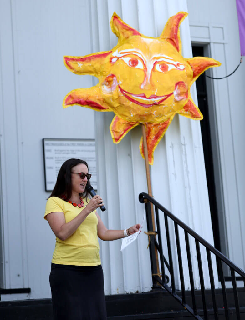 Kathryn Hopkins of the Climate Action Committee and Mothers Out Front speaks during “Sun Day.”