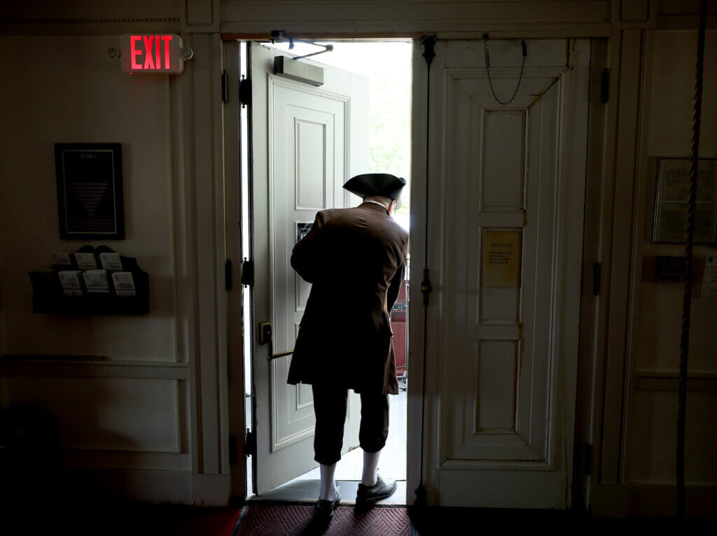 Moderator Tom Wilson of the Wright Tavern Legacy Trust steps out of the First Parish in Acton before a reading of the Declaration of Independence on Saturday, July 11, 2026. Ken McGagh/The Acton Bridge