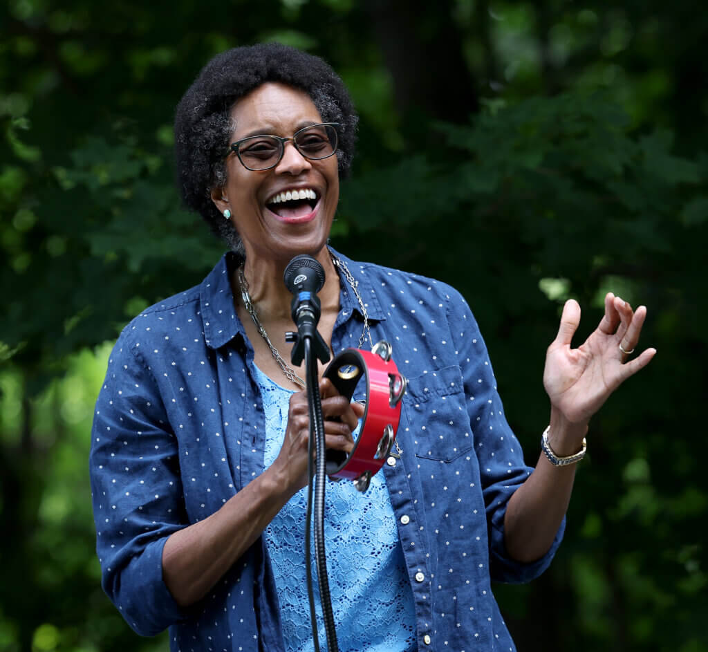 Merle Perkins of the “What the World Needs Now: Interfaith Coalition Singers” sings. 
