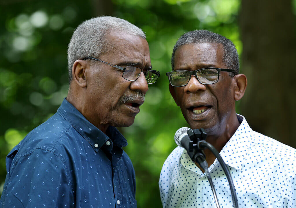Singers Walter Cooper, left, and Stephen Cooper, of the “What the World Needs Now: Interfaith Coalition Singers." 