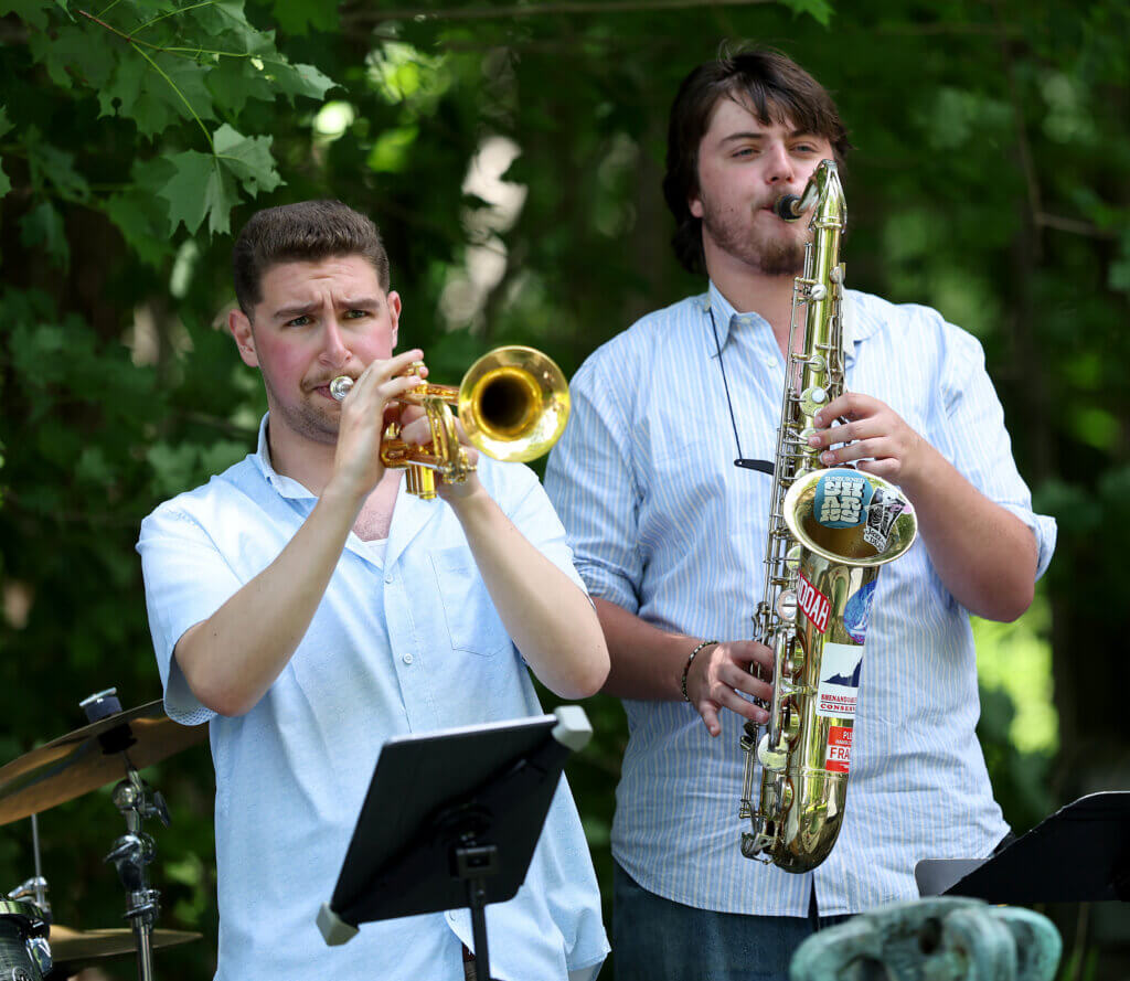 Trumpet player Trey Finkelstein, left, and saxophone player Spencer Cook of the Portland, Maine-based Sunburned Sharks perform.