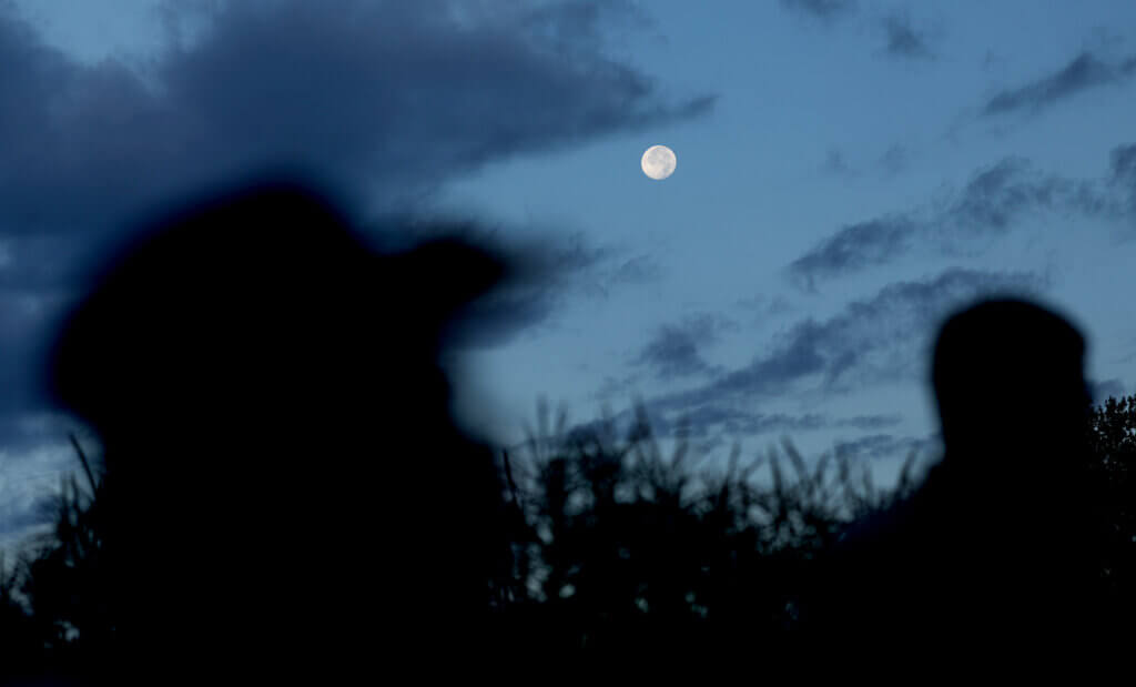 A full moon rises over the early risers at Verrill Farm before an early morning corn picking opportunity for the community at Verrill Farm on Saturday, August 29, 2026. Ken McGagh/The Acton Bridge