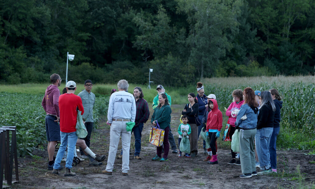 A group of about twenty local residents get a briefing from Verrill Farm patriarch Steve Verrill before heading out in the field to pick a few ears of corn on Saturday, August 29, 2026. Ken McGagh/The Acton Bridge