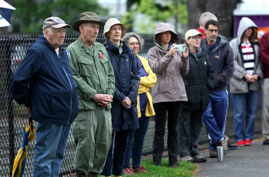 A reflective moment during the West Acton observance.  

