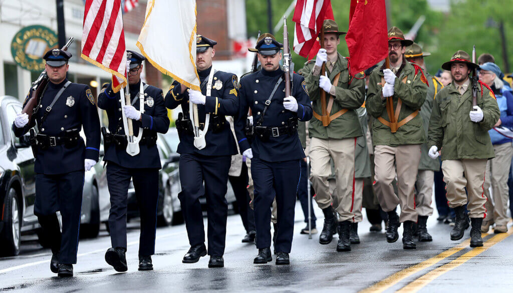 The Acton Police honor guard and Acton Independent Battery march in Acton Center.  Ken McGagh/The Acton Bridge 
