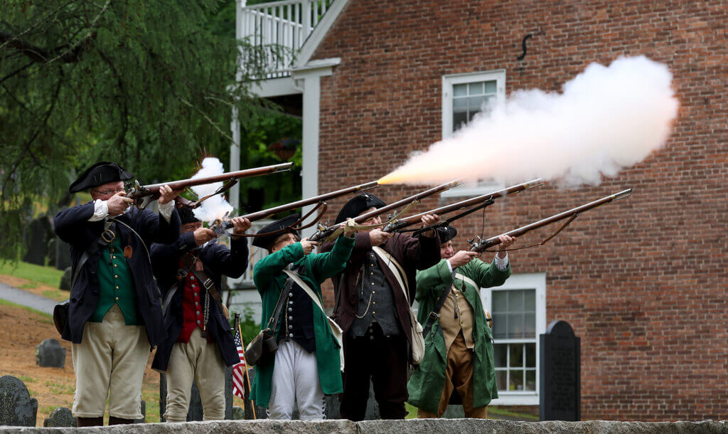 The Acton Minute Men fire a musket salute from the Old Hill Burying Ground at the conclusion of Memorial Day ceremonies in Acton Center.  