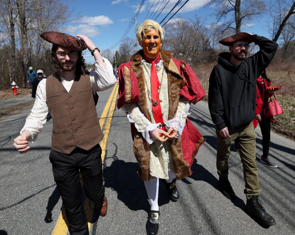 Playing an imprisoned King George but also intentionally resembling the current American president, Jeffrey Merriam of Uxbridge, center, flanked by sons Eric and Zachary Merriam, walks the parade route. The trio were among many descendants of the Meriam family on hand, some with one ‘“r” in their last names and others with two.
