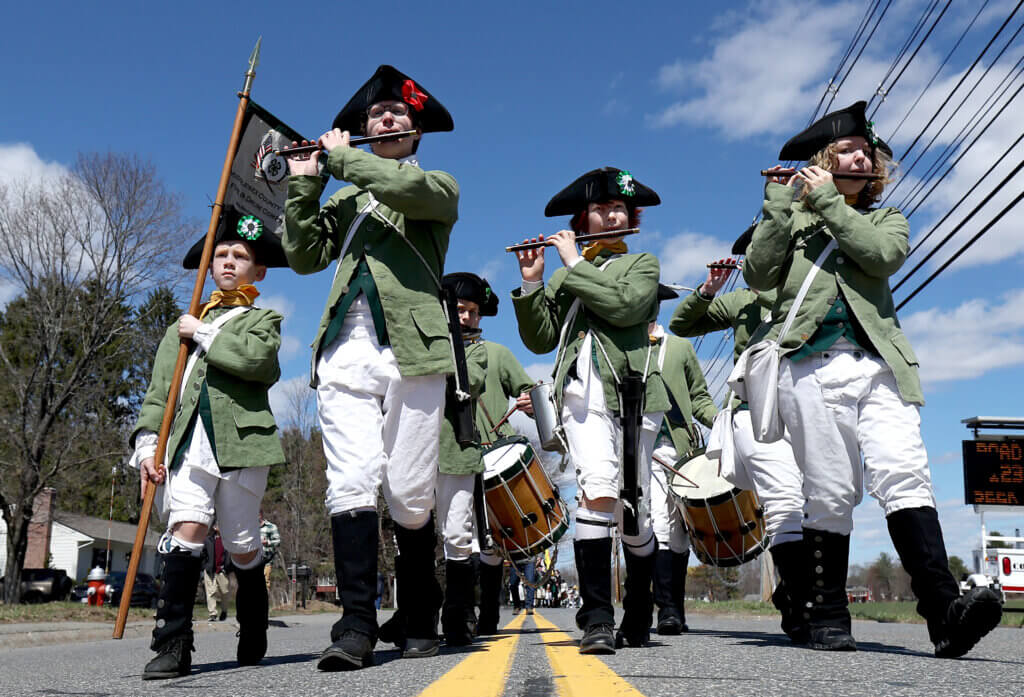 The Middlesex County Fife and Drum Corps, with standard bearer Jackson White, 8, of Acton at far left, play their way along the parade route.
