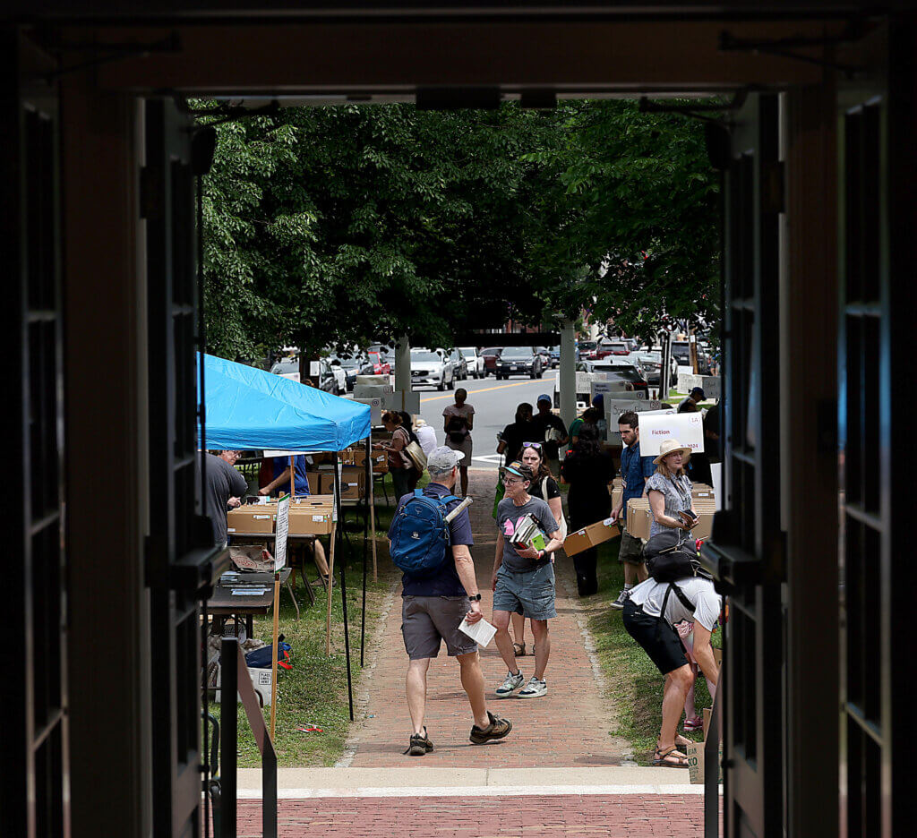 The library entrance frames book shoppers on the lawn.