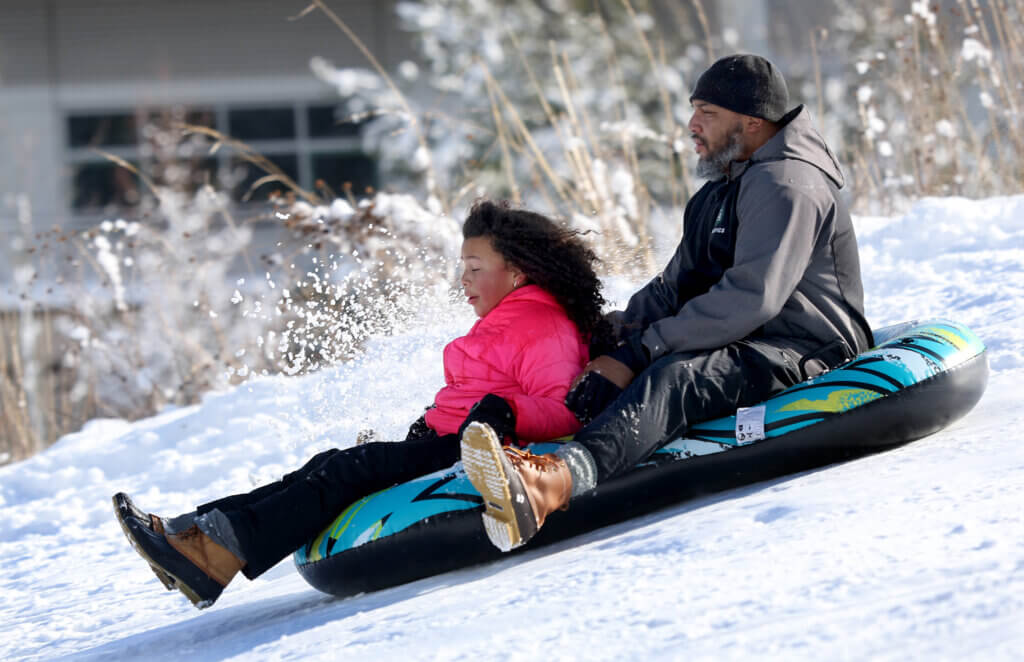 Grant Hightower of Acton and his daughter Solenne, 9, brace for their imminent descent. 