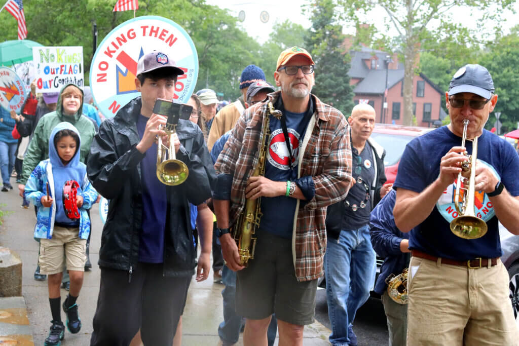 A small group plays patriotic songs at the front of the parade.