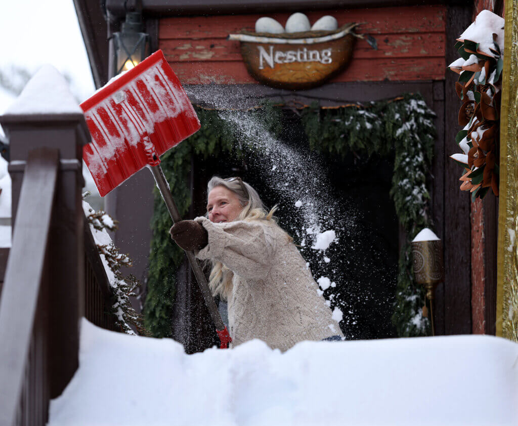 Nesting owner Wendi Snider shovels her stairs. Photo: Ken McGagh/The Acton Bridge