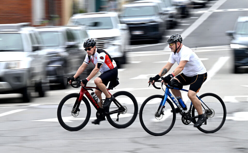 Cyclists speed through Acton Center.