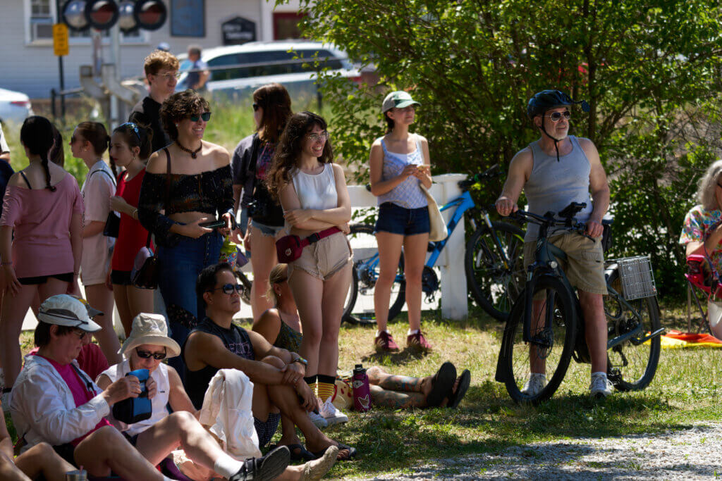 _DSC0724 - Fans watching Funky Sock Puppets - including Acton residents, John Teng (sitting on ground), Mark Boasberg (on bike); also Grace and Emma Vaughn (standing and smiling - not from Acton). Photo by Edward Feather