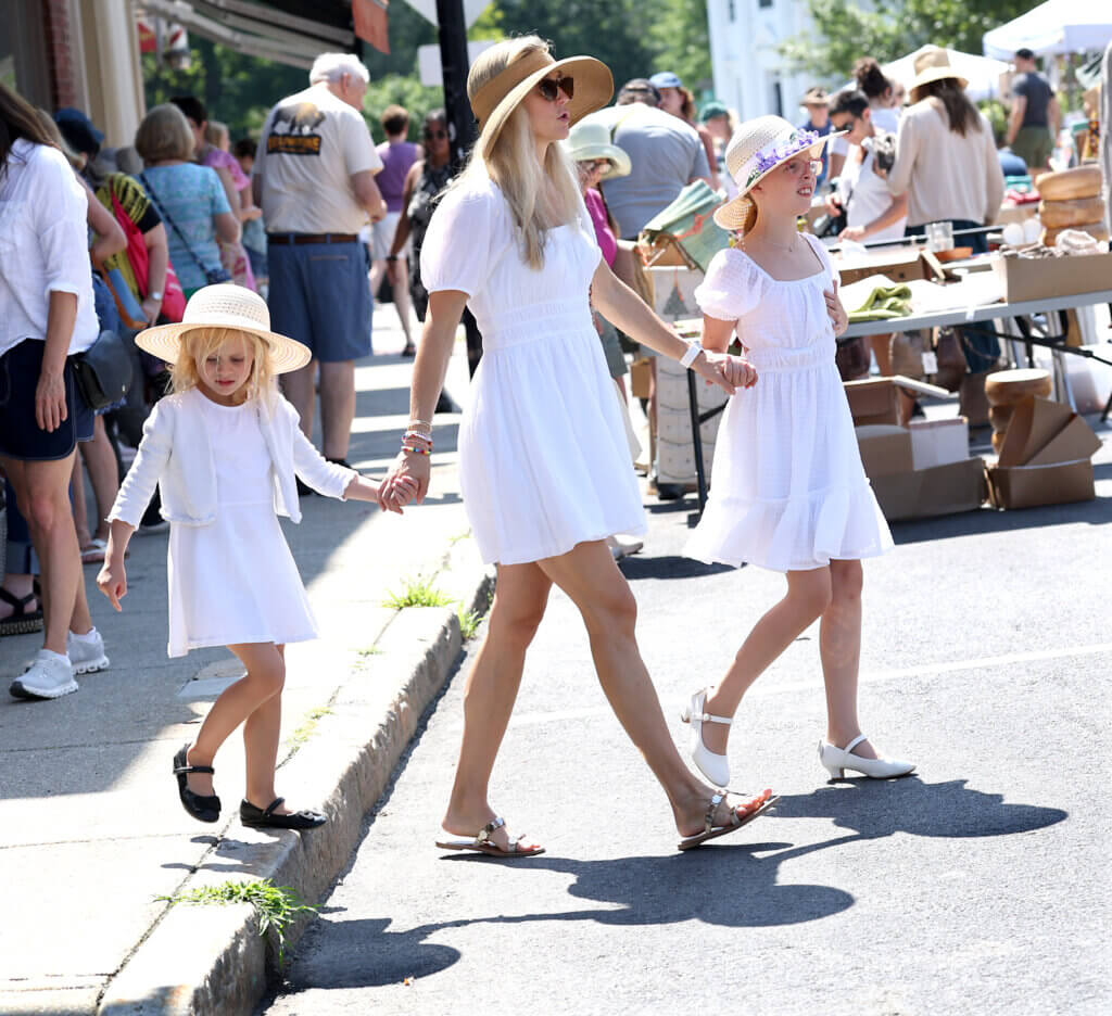 Jessica Larson of Wayland and her daughters Grace, 4, and June, 9, visited Acton Center dressed in white, an homage to the women's suffrage movement. 