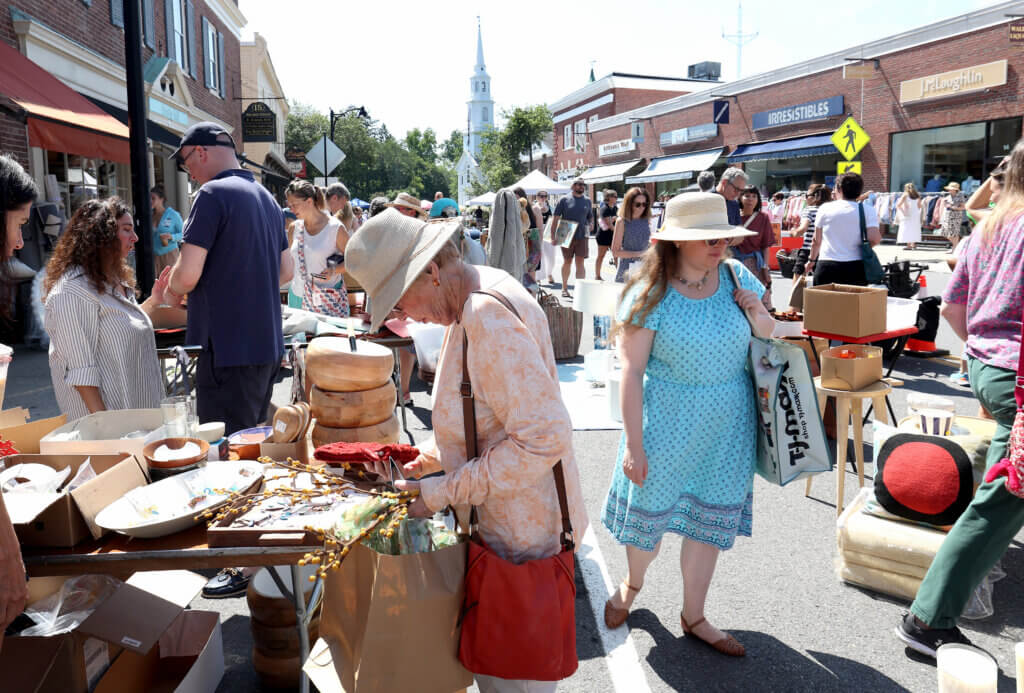 Shoppers peruse goods from Comina, a home furnishings and gift boutique.