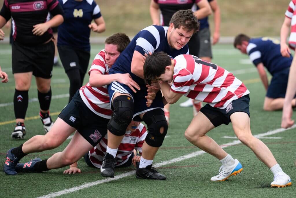Olin Waters (left) and Will Gesta (right) team up for a tackle. Photo by Jon Straggas