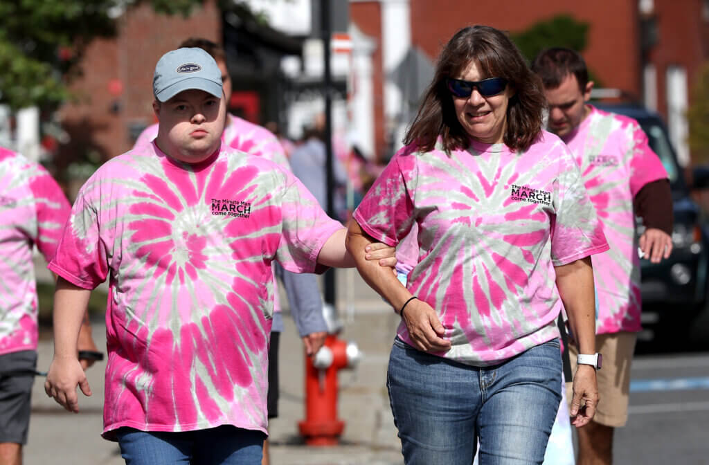 Ruth Goulet of Acton, right, leads her son Joey, 30, through Acton Center during Minute Man Arc’s 22nd annual Minute Man March on Saturday, September 19, 2026. Ken McGagh/The Acton Bridge