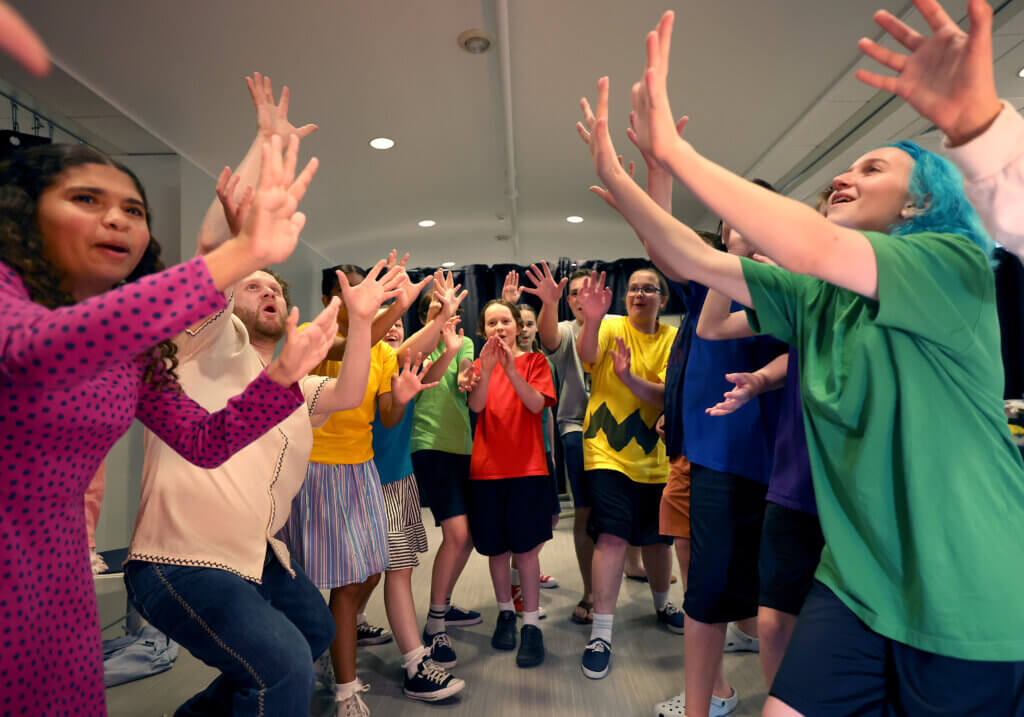 The cast of “You’re A Good Man Charlie Brown” perform a lively warm up before the show on Thursday, July 23, 2026. Ken McGagh/The Acton Bridge