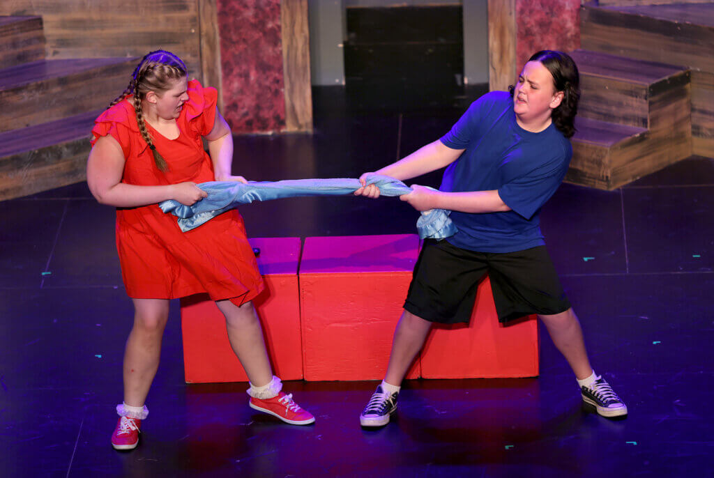 Linus, right, (Griffin Lester) and Lucy (Madeleine Kagels) battle for Linus’ blanket during the Acton Youth Theatre Summer Stock Troupe production of “You’re A Good Man Charlie Brown” in West Acton on Thursday, July 23, 2026. Ken McGagh/The Acton Bridge