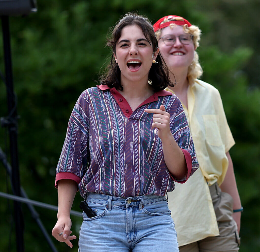 Maggie Stewart of Acton, as Gregory, performs on the outdoor stage at Acton Free Public Library lawn during the Acton Players presentation of “Romeo And Juliet” on Saturday, August 1, 2026. Stewart is a 2026 Emerson College graduate and a first time performer with Acton Players. A total of eight cast members made their The World's A Stage Players debut in this year's production. Ken McGagh/The Acton Bridge