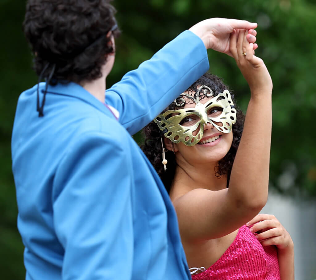 Shakespeare's timeless tragedy gets a 1980's reimagining Eliza Zangerl, as Juliet, dances with her Romeo during the masquerade ball scene at the Acton Free Public Library lawn on Saturday, August 1, 2026. Ken McGagh/The Acton Bridge