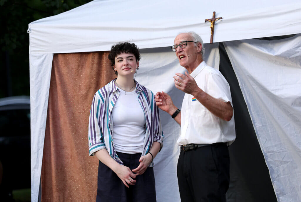 Ed Bernard of Acton, right, as Pastor Lawrence, and Sara Gluck as Romeo, in a scene from “Romeo And Juliet” at the Acton Free Public Library lawn on Saturday, August 1, 2026. Ken McGagh/The Acton Bridge