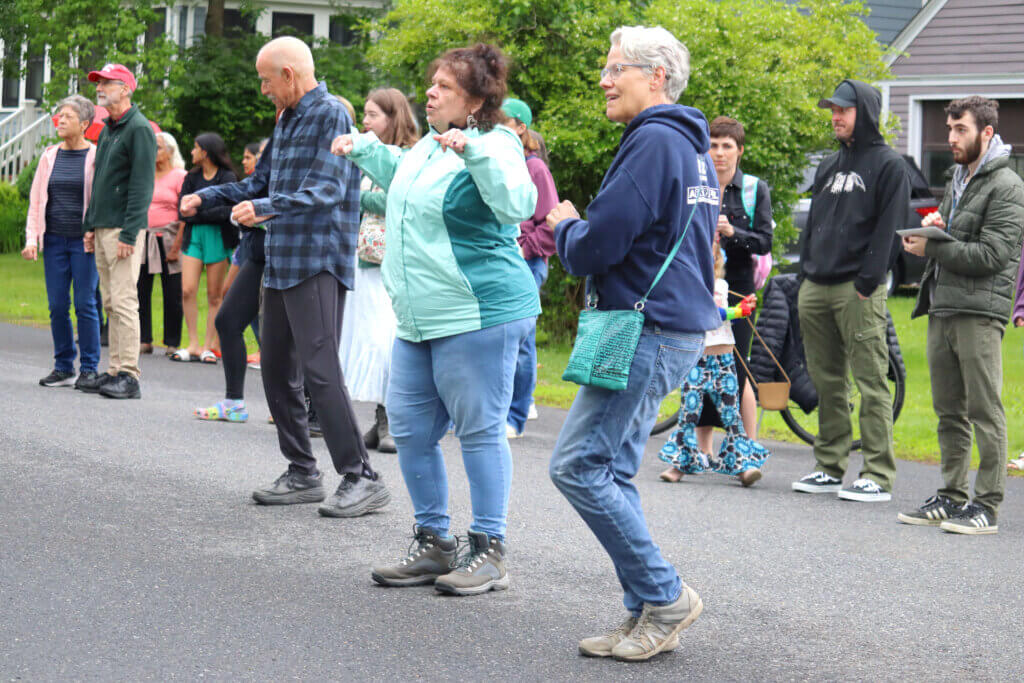 Karen Kashian, Margot Kimball, and Mitch Levine dance in the street. Photo: Trace Salzbrenner/The Acton Bridge