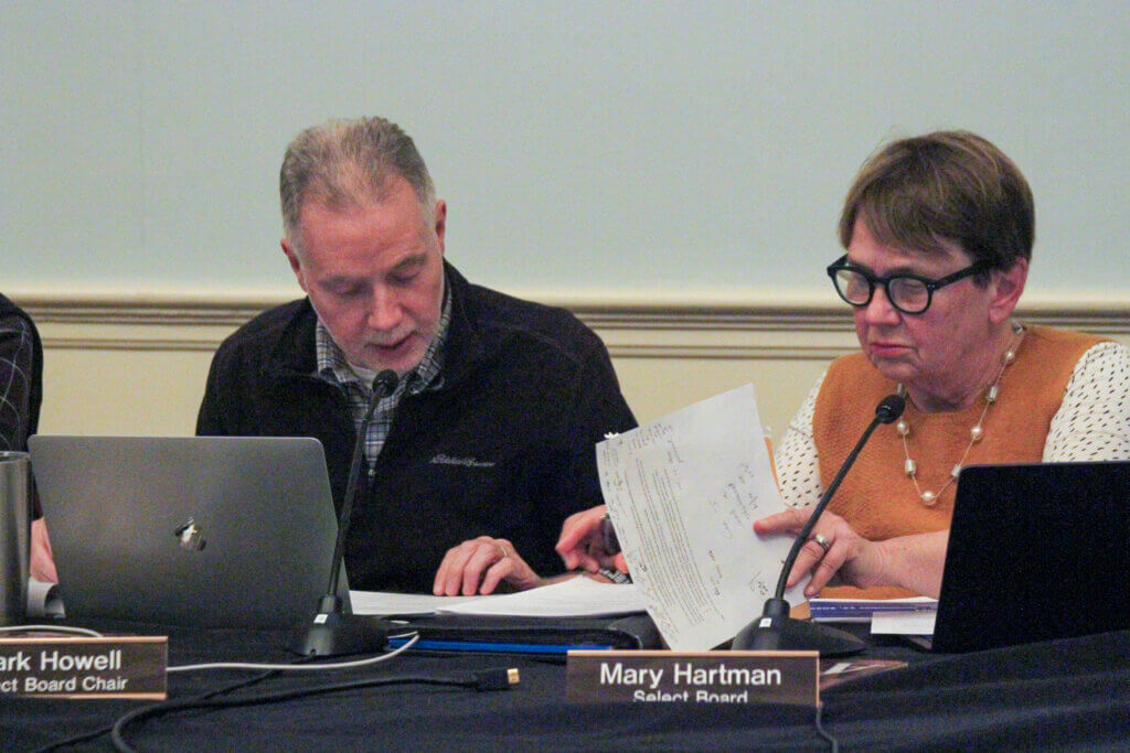 Select Board Chair Mark Howell and board member Mary Hartman organize their notes during Monday’s Select Board meeting. Photo: Dakota Antelman/The Acton Bridge