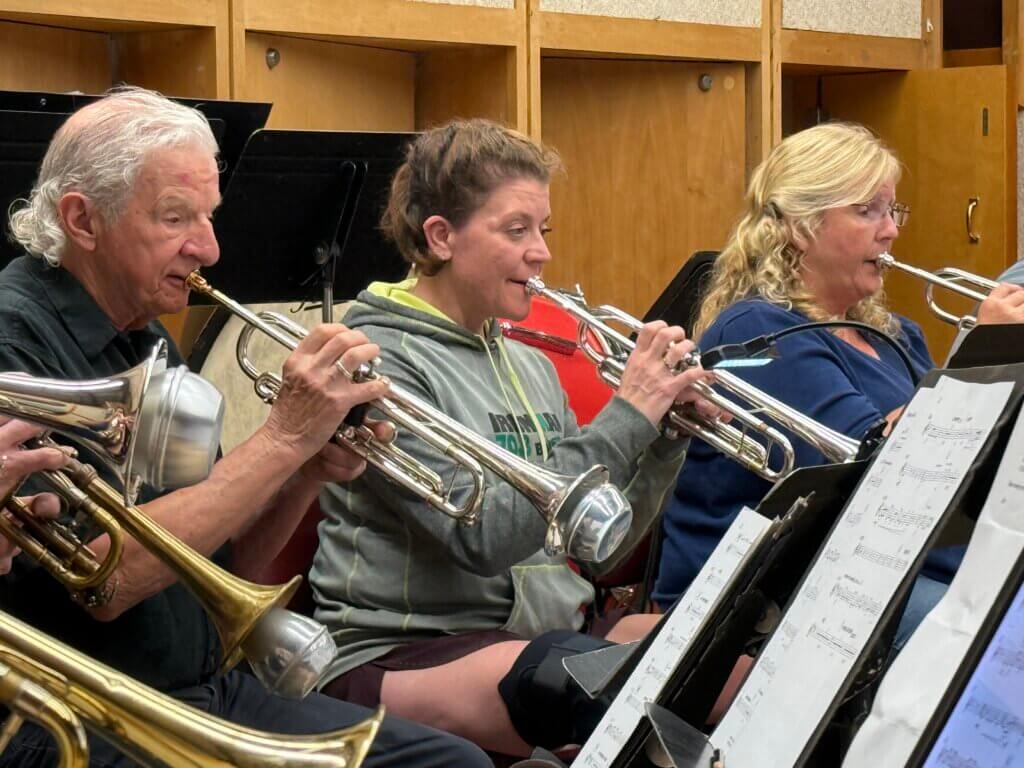 Trumpet players Margaret Romero of Acton, center, with Rich Given of Ayer and Cindy Blanchard of Boxborough. Photo: Laurie O’Neill/The Acton Bridge