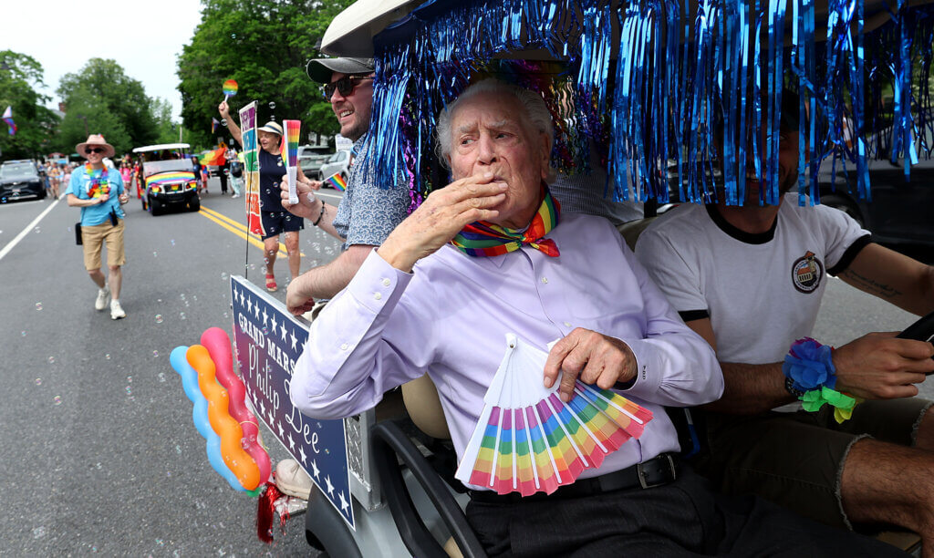 Acton Pride parade Grand Marshal Phillip B. Dee Jr., 86, of Dee Funeral Home in Acton, blows a kiss to the crowd during the Acton Pride Festival’s March Down Main on Saturday, June 6, 2026. Ken McGagh/The Acton Bridge