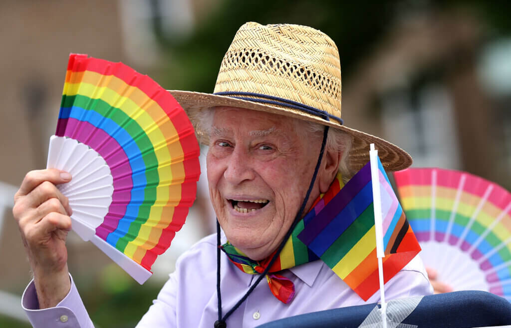 Parade Grand Marshal Philip B. Dee Jr. enjoys a drag show from Mizery Loves Company during the Acton Pride Festival’s March Down Main on Saturday, June 6, 2026. Ken McGagh/The Acton Bridge