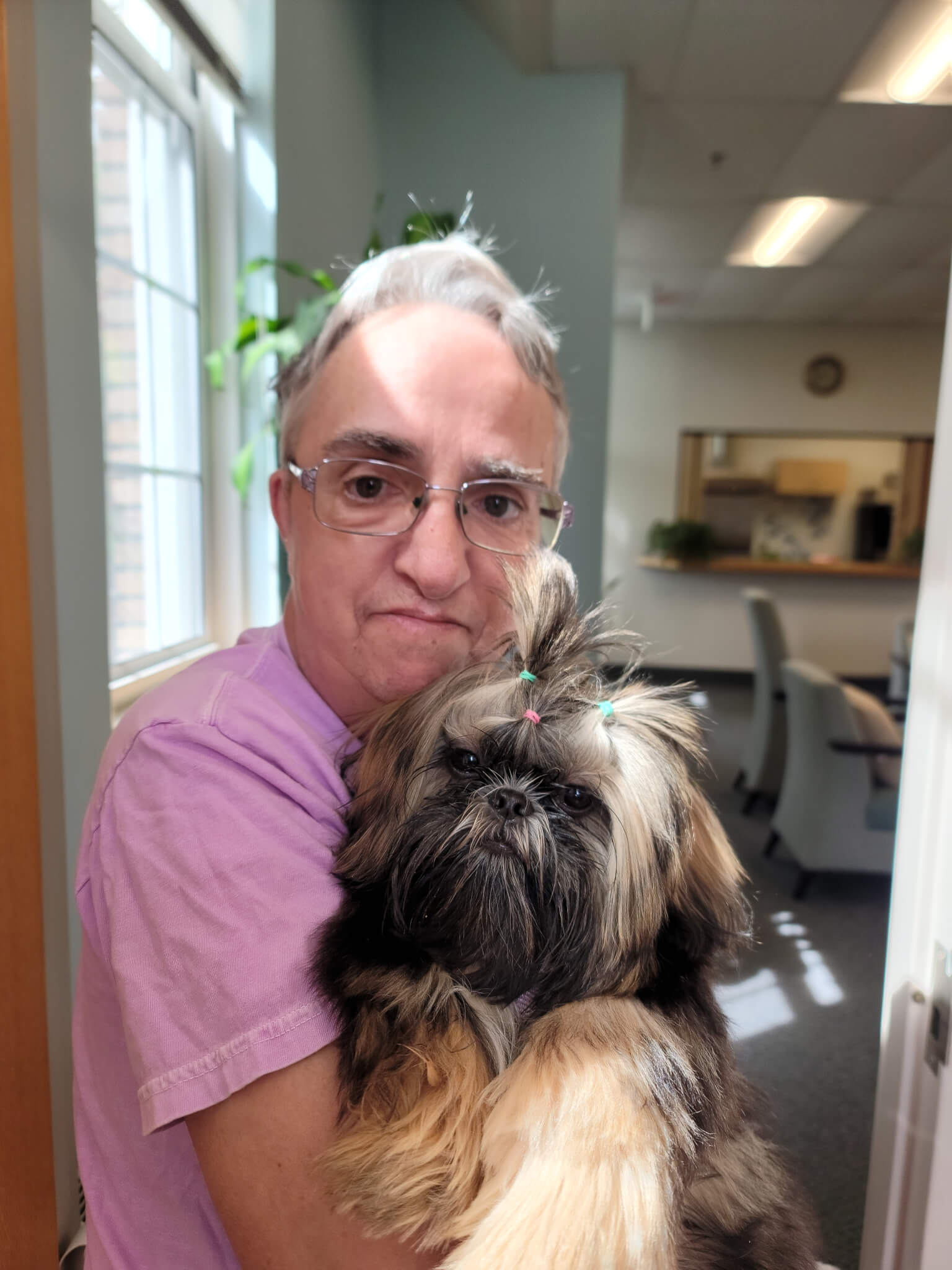 Janice Smith has so connected with Momo, the Council on Aging’s comfort dog, that she stops in specifically to visit with the pup. Courtesy photo