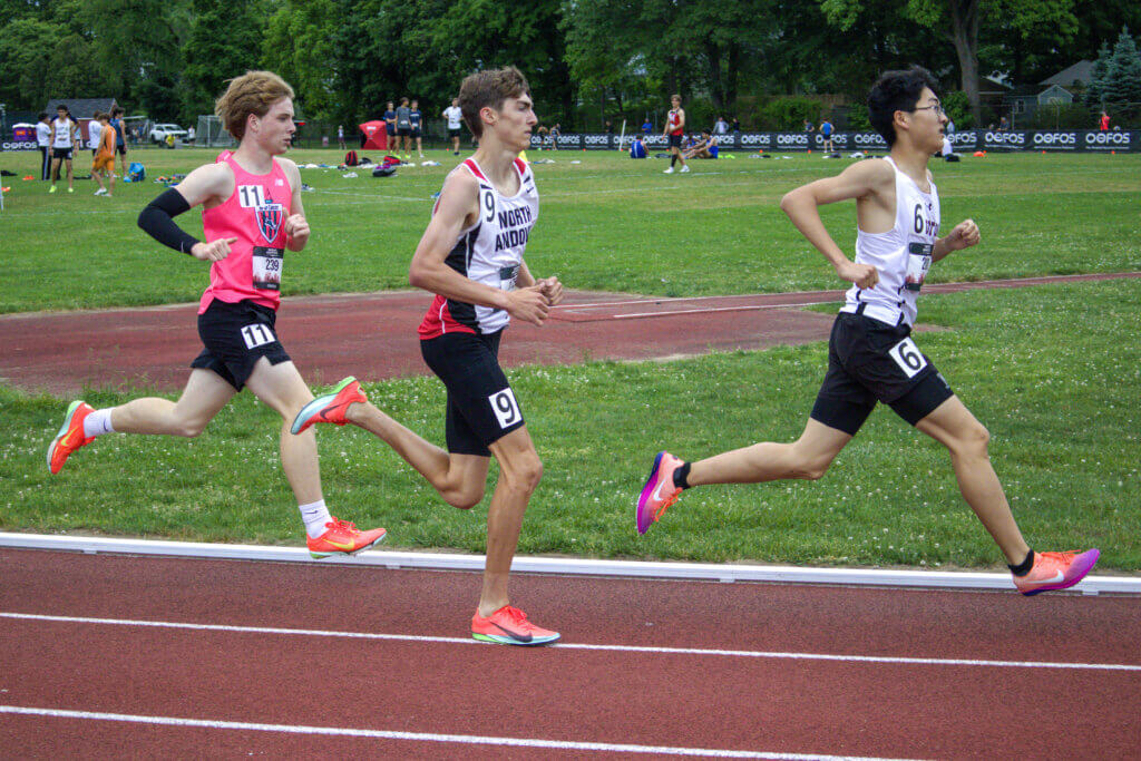 Recent CCHS graduate Jay Bodenrader, in Kicks shirt, competes in the scholastic mile. Photo by Emma Green