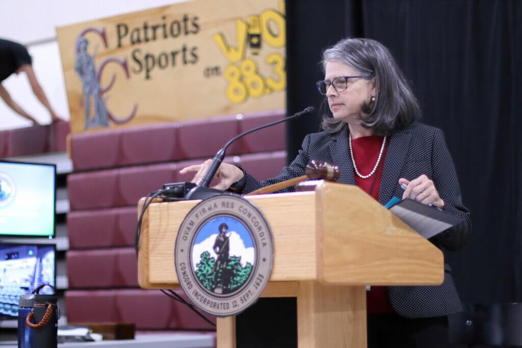 Town Moderator Carmin Reiss asks visitors to settle in for Tuesday’s deliberations. Photo: Trace Salzbrenner/The Acton Bridge